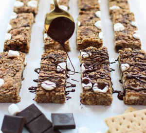 smores granola bars being drizzled with chocolate