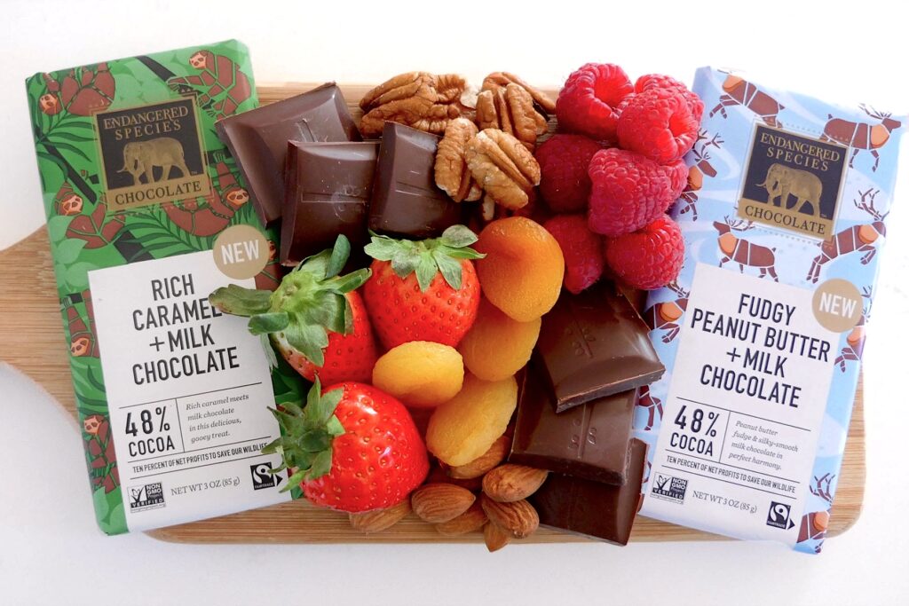 A spread of fruits, nuts and delicious chocolate.